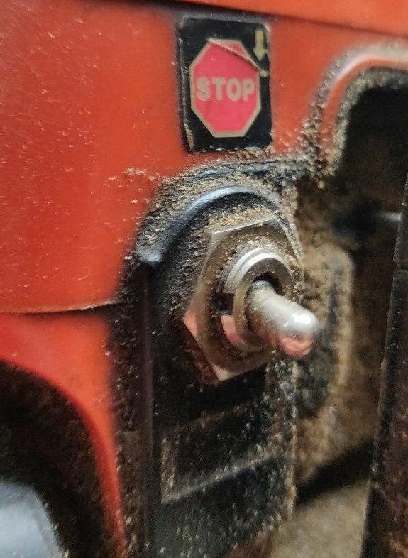 A close-up photo of the switch of the chainsaw